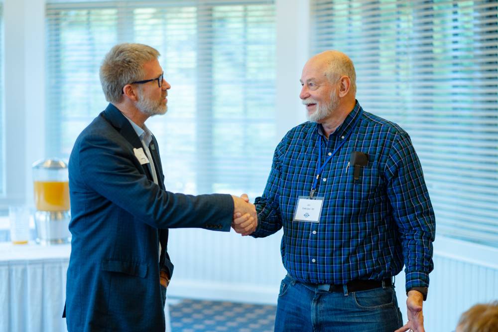 Speaker and attendee shaking hands